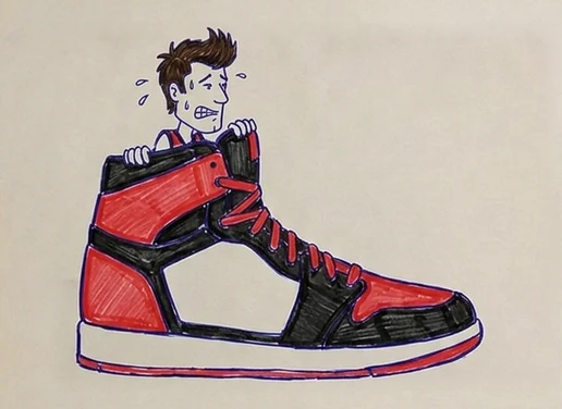 A tiny Elijah Pepper peeking out of a giant basketball shoe